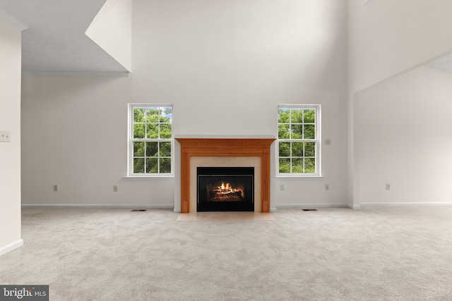 542 June Apple Ct, Abingdon, MD 21009 - unfurnished living room with a high ceiling, carpet flooring, a fireplace, and baseboards