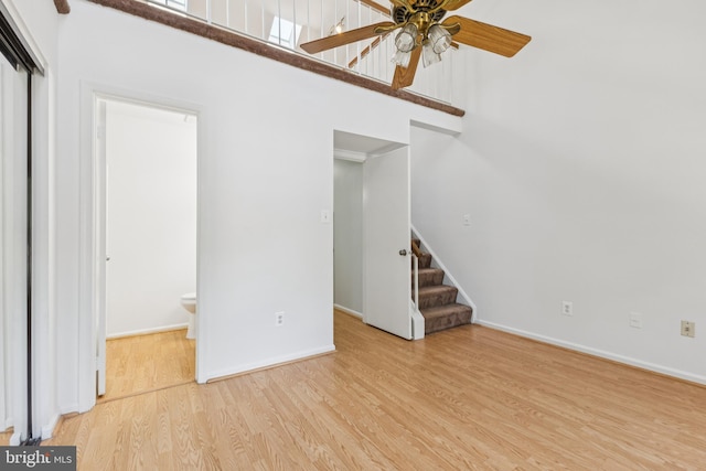 8485 Laurel Oak Dr, Springfield, VA 22153 - unfurnished living room featuring ceiling fan, wood finished floors, stairs, and a high ceiling