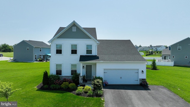 4052 Country Dr, Dover, PA 17315 - view of front of home featuring a garage, driveway, a front lawn, and board and batten siding