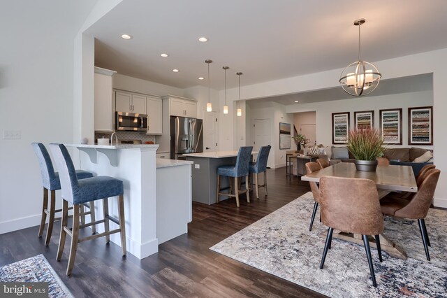 4052 Country Dr, Dover, PA 17315 - dining room featuring recessed lighting, dark wood-type flooring, a chandelier, and baseboards