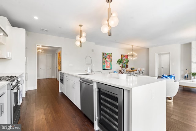 427 E Lancaster Ave Unit 1202, Wayne, PA 19087 - kitchen with wine cooler, stainless steel appliances, a chandelier, white cabinetry, and recessed lighting