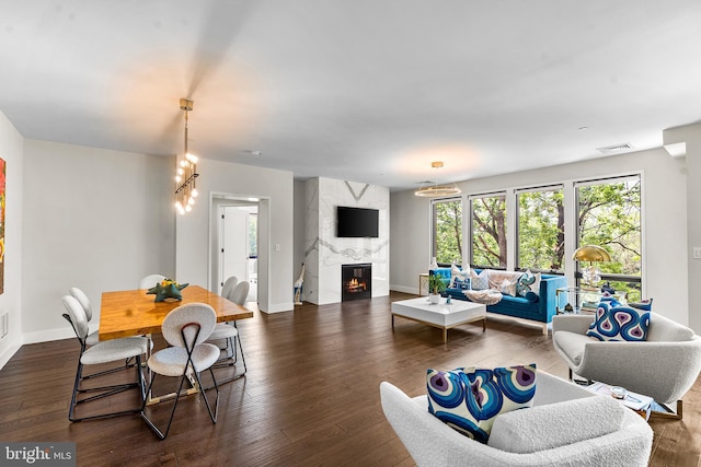 427 E Lancaster Ave Unit 1202, Wayne, PA 19087 - living room featuring a premium fireplace, dark wood finished floors, and a chandelier