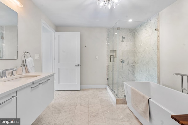 427 E Lancaster Ave Unit 1202, Wayne, PA 19087 - bathroom featuring a soaking tub, vanity, marble look tiles, and a shower stall