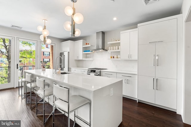 427 E Lancaster Ave Unit 1202, Wayne, PA 19087 - kitchen with extractor fan, open shelves, appliances with stainless steel finishes, a center island with sink, and white cabinets