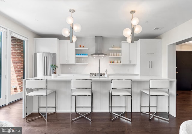 427 E Lancaster Ave Unit 1202, Wayne, PA 19087 - kitchen featuring exhaust hood, open shelves, high end refrigerator, light countertops, and dark wood-style floors
