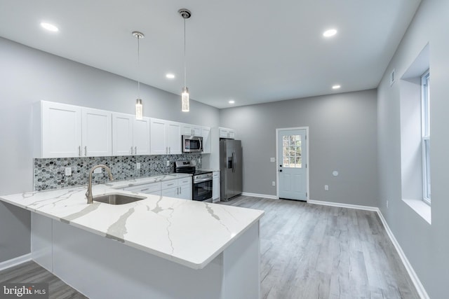 5229 Webster St, Philadelphia, PA 19143 - kitchen featuring stainless steel appliances, a sink, decorative backsplash, light wood-type flooring, and recessed lighting