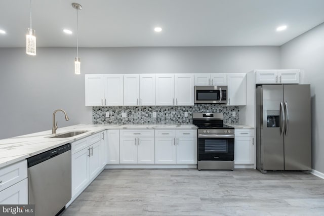 5229 Webster St, Philadelphia, PA 19143 - kitchen with stainless steel appliances, a sink, white cabinetry, tasteful backsplash, and recessed lighting