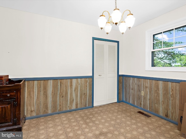 435 Yellow Spgs S, Laurel, MD 20724 - empty room featuring a wainscoted wall, a chandelier, wood walls, and tile patterned floors