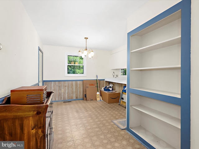 435 Yellow Spgs S, Laurel, MD 20724 - dining space with a chandelier, a wainscoted wall, light flooring, and wooden walls