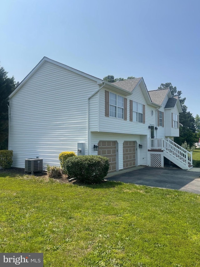 25795 Shamrock Ln, Mechanicsville, MD 20659 - view of home's exterior featuring central AC, driveway, a lawn, and an attached garage
