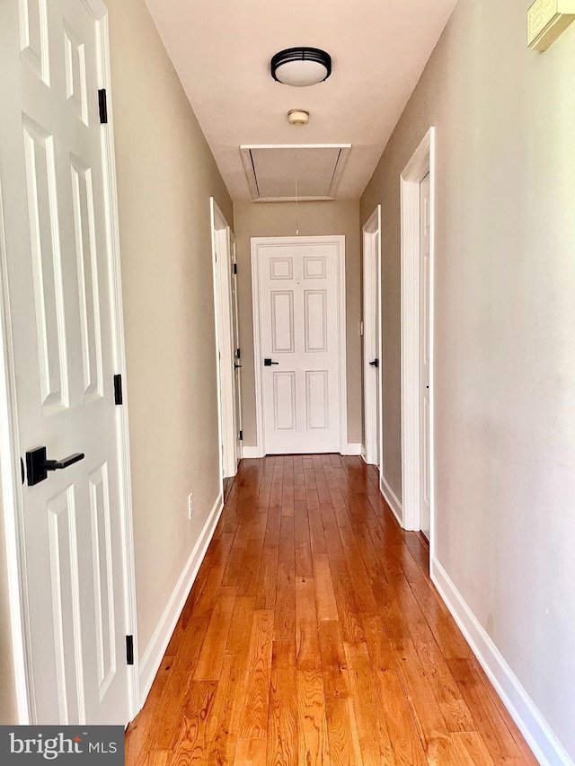25795 Shamrock Ln, Mechanicsville, MD 20659 - hallway with attic access, light wood-style floors, and baseboards