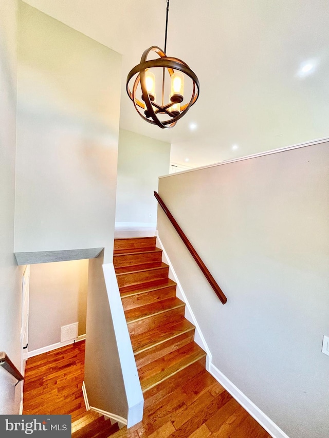25795 Shamrock Ln, Mechanicsville, MD 20659 - staircase with wood finished floors, a chandelier, baseboards, and recessed lighting