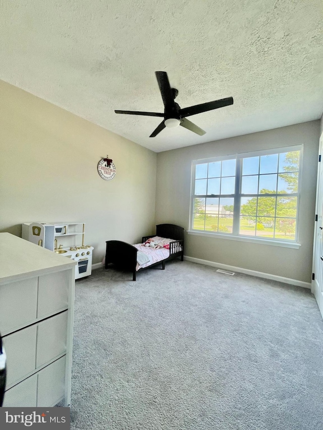 25795 Shamrock Ln, Mechanicsville, MD 20659 - bedroom featuring baseboards, carpet flooring, a textured ceiling, and a ceiling fan