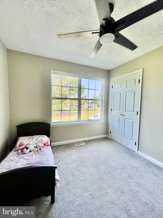 25795 Shamrock Ln, Mechanicsville, MD 20659 - carpeted bedroom with a textured ceiling, baseboards, and a ceiling fan