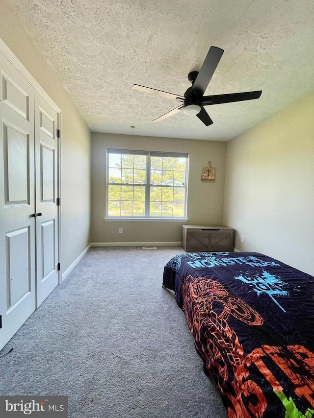 25795 Shamrock Ln, Mechanicsville, MD 20659 - carpeted bedroom with a textured ceiling, baseboards, and a ceiling fan