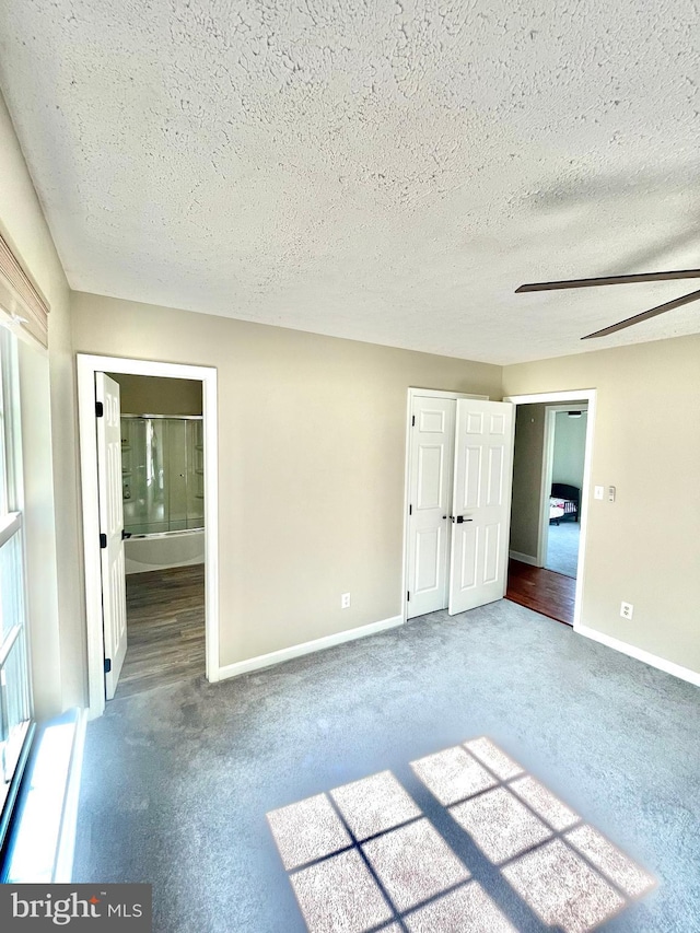 25795 Shamrock Ln, Mechanicsville, MD 20659 - unfurnished bedroom featuring carpet flooring, a textured ceiling, baseboards, and ensuite bathroom