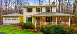 7193 Hall Tavern Ct, Manassas, VA 20112 - view of front facade featuring a garage and a chimney