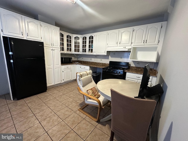 1707 Harman Ave, Baltimore, MD 21230 - kitchen featuring black appliances, glass insert cabinets, dark countertops, light tile patterned flooring, and white cabinets