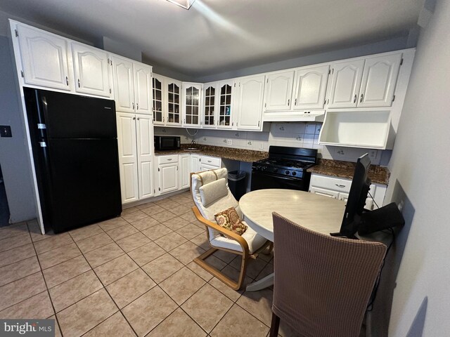 1707 Harman Ave, Baltimore, MD 21230 - kitchen featuring black appliances, glass insert cabinets, white cabinets, dark countertops, and under cabinet range hood