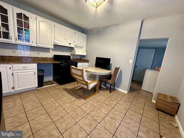 1707 Harman Ave, Baltimore, MD 21230 - kitchen with black gas stove, white cabinetry, light tile patterned floors, glass insert cabinets, and under cabinet range hood