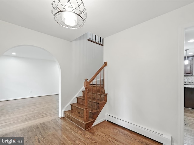2500 Sams Creek Rd, Westminster, MD 21157 - staircase with baseboard heating, arched walkways, wood finished floors, and recessed lighting