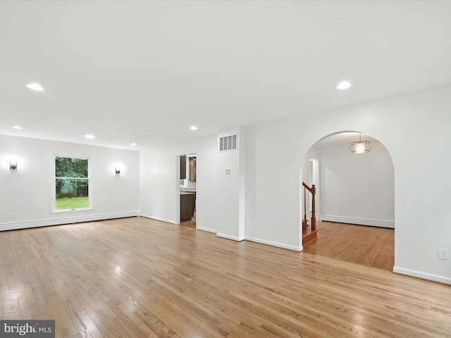 2500 Sams Creek Rd, Westminster, MD 21157 - empty room with arched walkways, light wood finished floors, recessed lighting, and a baseboard radiator