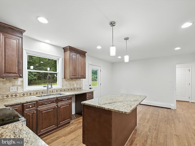 2500 Sams Creek Rd, Westminster, MD 21157 - kitchen featuring baseboard heating, backsplash, light wood-style flooring, a center island, and hanging light fixtures