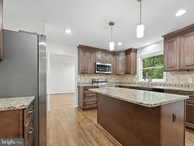 2500 Sams Creek Rd, Westminster, MD 21157 - kitchen with stainless steel appliances, light wood finished floors, decorative backsplash, hanging light fixtures, and recessed lighting