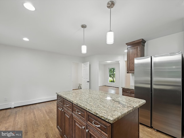 2500 Sams Creek Rd, Westminster, MD 21157 - kitchen with freestanding refrigerator, decorative light fixtures, light wood-style flooring, light stone counters, and recessed lighting