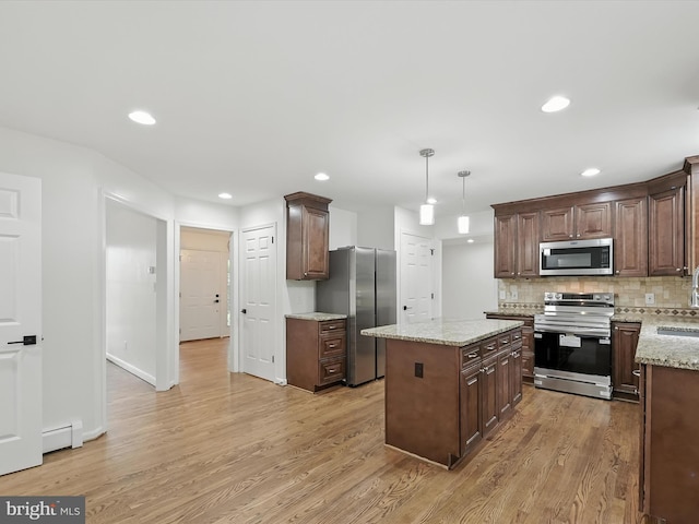 2500 Sams Creek Rd, Westminster, MD 21157 - kitchen featuring appliances with stainless steel finishes, baseboard heating, light wood-type flooring, backsplash, and a center island