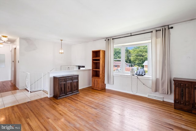 10520 Truxton Rd, Hyattsville, MD 20783 - unfurnished living room featuring wood finished floors and baseboards