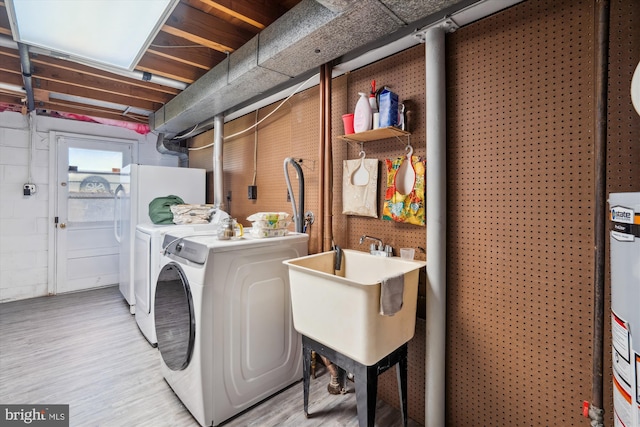 10520 Truxton Rd, Hyattsville, MD 20783 - washroom with washer and clothes dryer and light wood-style floors