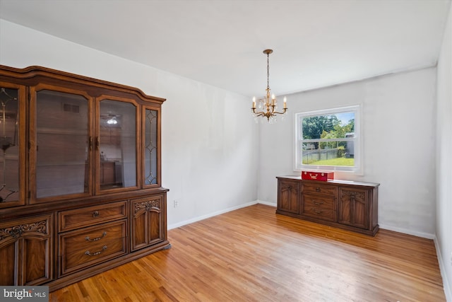 10520 Truxton Rd, Hyattsville, MD 20783 - dining area with a chandelier, light wood-type flooring, and baseboards