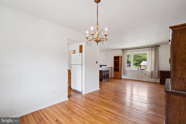 10520 Truxton Rd, Hyattsville, MD 20783 - unfurnished living room with light wood-style floors, a chandelier, and baseboards