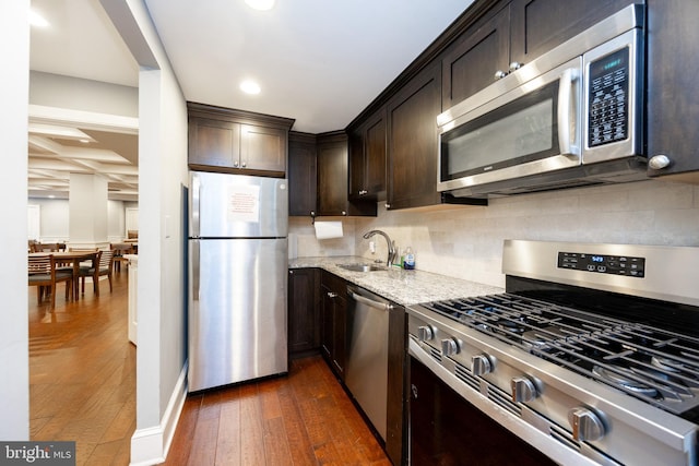 309 Florence Ave Unit 420-N, Jenkintown, PA 19046 - kitchen featuring stainless steel appliances, dark wood finished floors, light stone countertops, dark brown cabinetry, and recessed lighting
