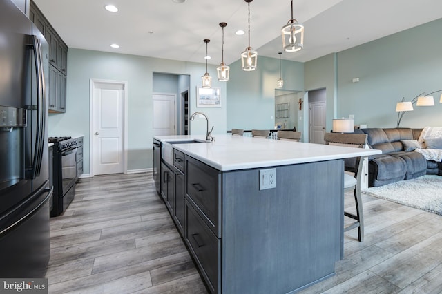 2017 Chamberlain Dr, Frederick, MD 21702 - kitchen with black appliances, light wood finished floors, a sink, a kitchen breakfast bar, and recessed lighting