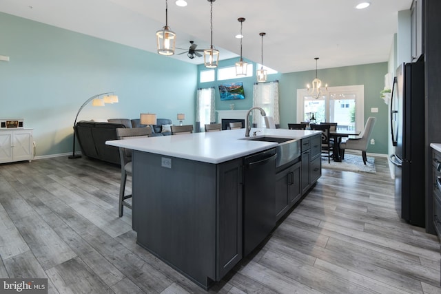 2017 Chamberlain Dr, Frederick, MD 21702 - kitchen featuring dishwashing machine, a sink, freestanding refrigerator, a chandelier, and plenty of natural light