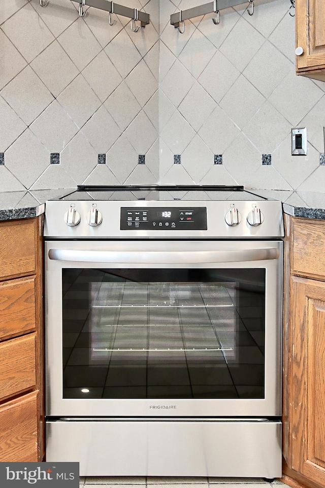 1805 Crystal Dr Unit 1110S, Arlington, VA 22202 - detailed view of brown cabinets, dark countertops, and oven