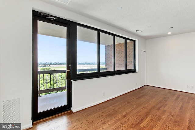 1805 Crystal Dr Unit 1110S, Arlington, VA 22202 - unfurnished room with wood finished floors, a textured ceiling, and recessed lighting