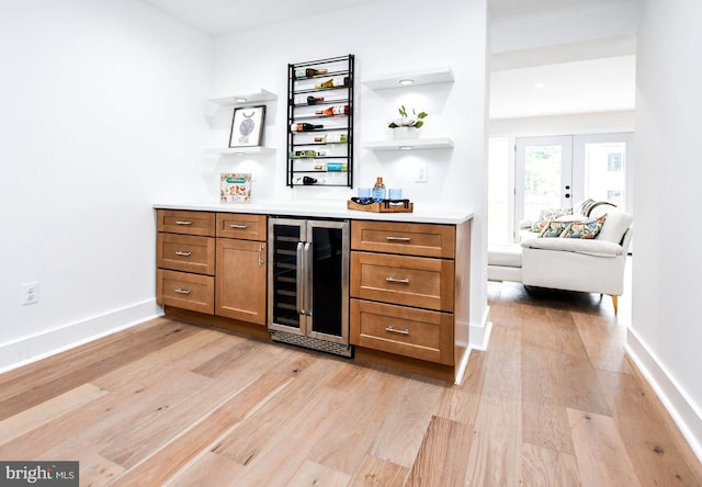 4324 Yuma St NW, Washington, DC 20016 - indoor dry bar with beverage cooler, light wood-style flooring, french doors, and baseboards