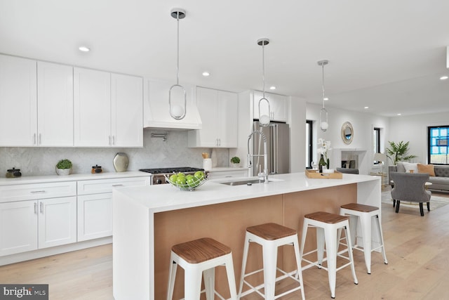 4324 Yuma St NW, Washington, DC 20016 - kitchen featuring high end fridge, white cabinetry, decorative backsplash, light wood-style flooring, and recessed lighting