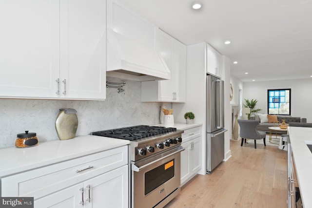 4324 Yuma St NW, Washington, DC 20016 - kitchen with appliances with stainless steel finishes, white cabinetry, recessed lighting, light countertops, and light wood-style flooring