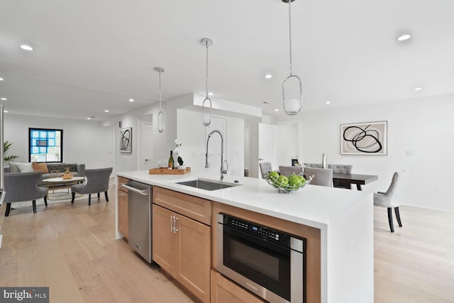 4324 Yuma St NW, Washington, DC 20016 - kitchen with a sink, open floor plan, light wood-style flooring, stainless steel appliances, and light countertops