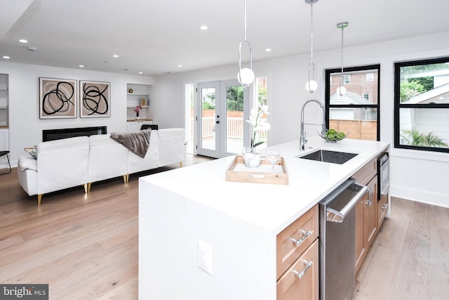4324 Yuma St NW, Washington, DC 20016 - kitchen with a sink, appliances with stainless steel finishes, light wood-style flooring, french doors, and light countertops