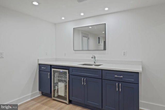 4324 Yuma St NW, Washington, DC 20016 - bar with a sink, wine cooler, light wood-style flooring, baseboards, and recessed lighting