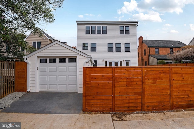 4324 Yuma St NW, Washington, DC 20016 - view of front of home featuring an outbuilding, a garage, and asphalt driveway