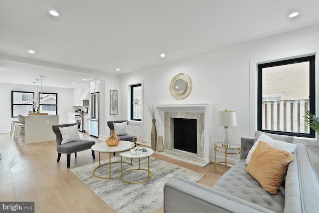 4324 Yuma St NW, Washington, DC 20016 - living room featuring light wood-style flooring, plenty of natural light, recessed lighting, a premium fireplace, and baseboards