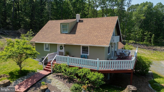 402 Swamp Rd, Morgantown, PA 19543 - view of front of property featuring a chimney, a shingled roof, a deck, and a wooded view
