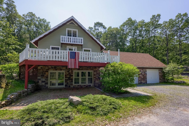 402 Swamp Rd, Morgantown, PA 19543 - rear view of house featuring french doors, stone siding, a balcony, and a deck
