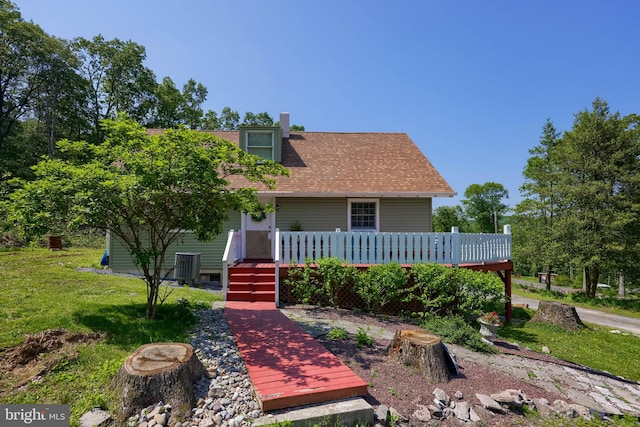 402 Swamp Rd, Morgantown, PA 19543 - view of front of home featuring a deck, central AC, a front yard, and a chimney